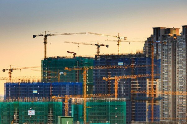 A Busting High-rise construction site with multiple cranes