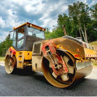 Construction Equiptment rolling out highway pavement